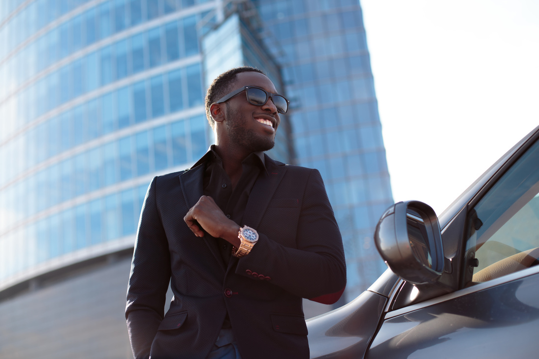 Man Wearing an All Black Suit with a Luxurious Watch 